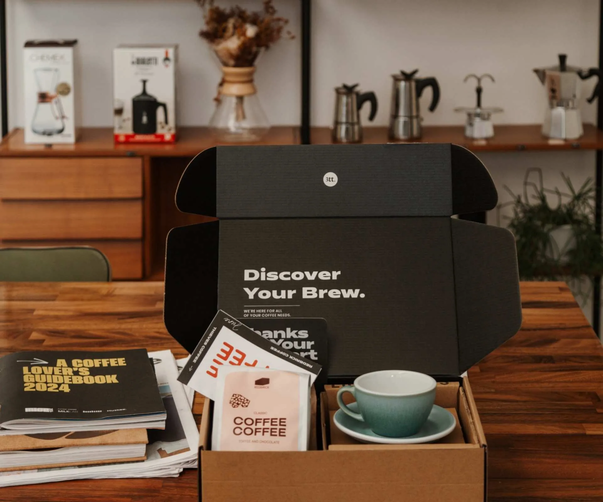 Thieves coffee subscription on a table with coffee and coffee cups inside