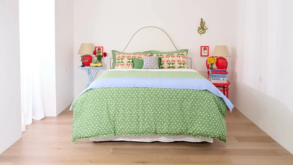 Modern bedroom with green and red colour theme and timber flooring from Carpet Court'as 'Amalfi' range.