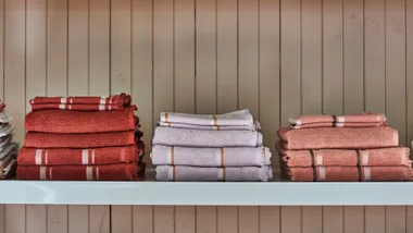 red, purple and pink folded towels