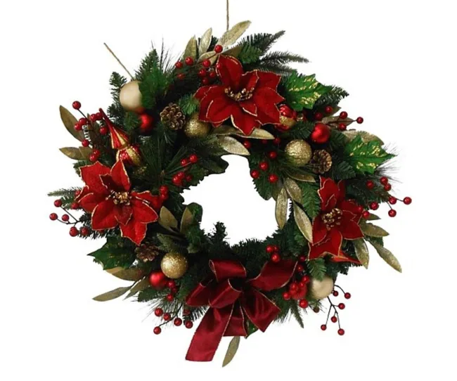 Festive Christmas wreath with red flowers, gold accents, pinecones, and a red bow.