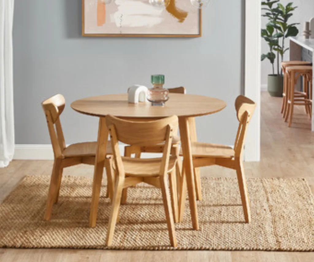 larsen dining chair set of four around a wooden dining table in light wood colour