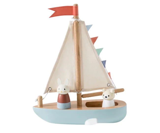 wooden sailboat with painted hull, small boat goer toys and a red flag at the top