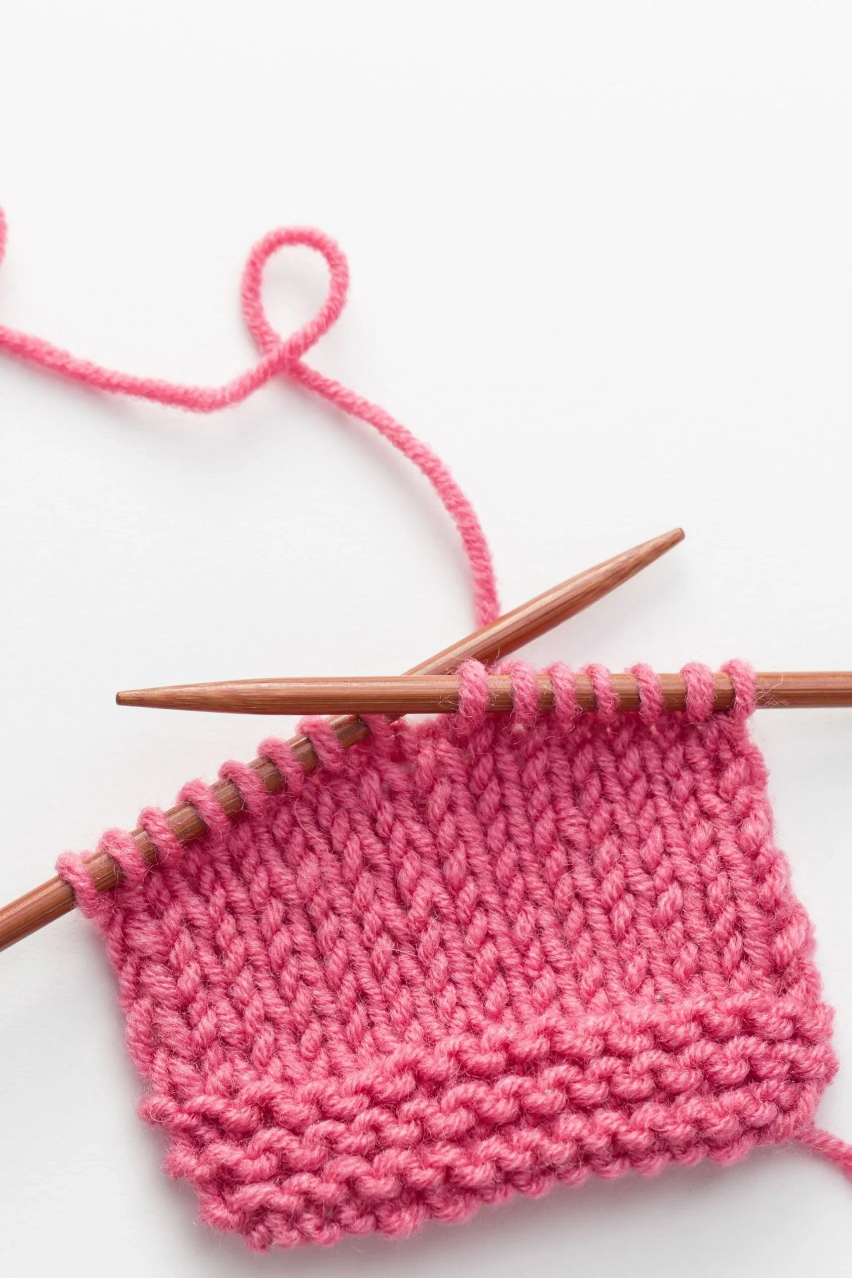 pink knitting yarn and needle