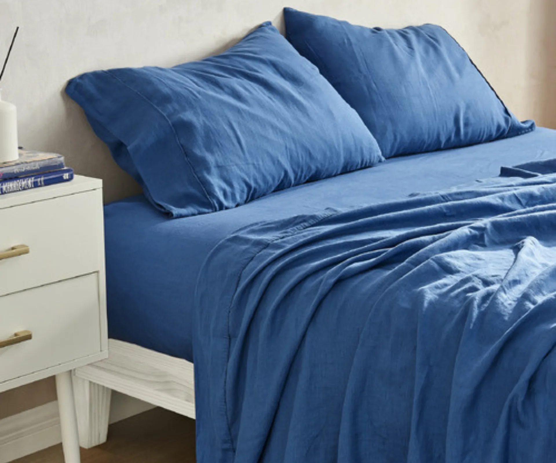 navy royal blue linen sheet set creased and folded 