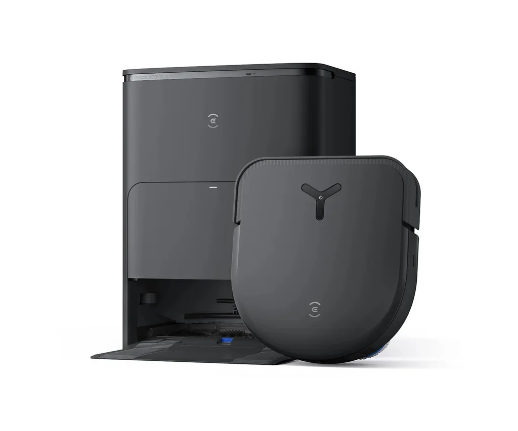 deebot vacuum standing next to cleaning station with triangular symbol on top