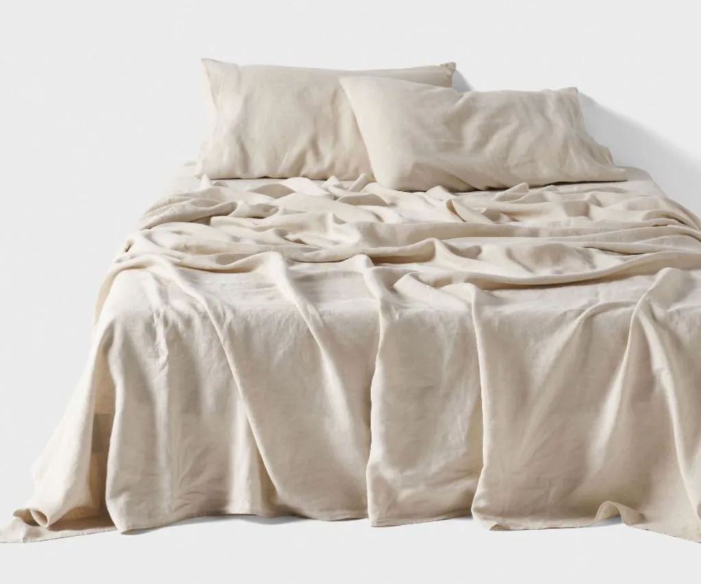 grey beige linen sheets rustled on the bed