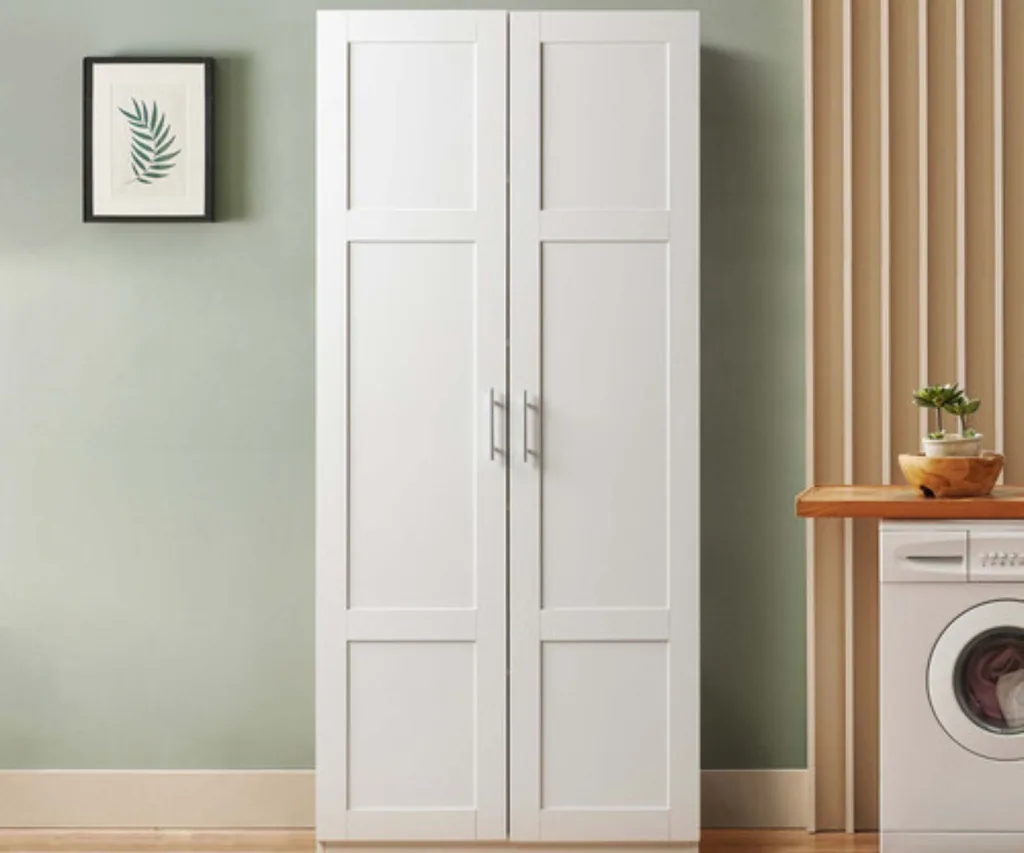 white two door cupboard with wood panelling and green wall behind it