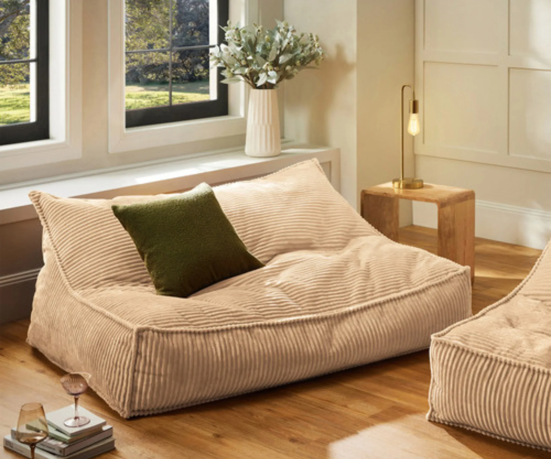 cream corduroy bean bag with green cushion on it