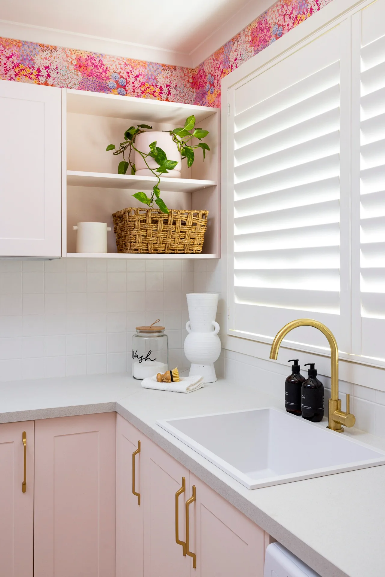 pink pastel kitchen with gold tapware