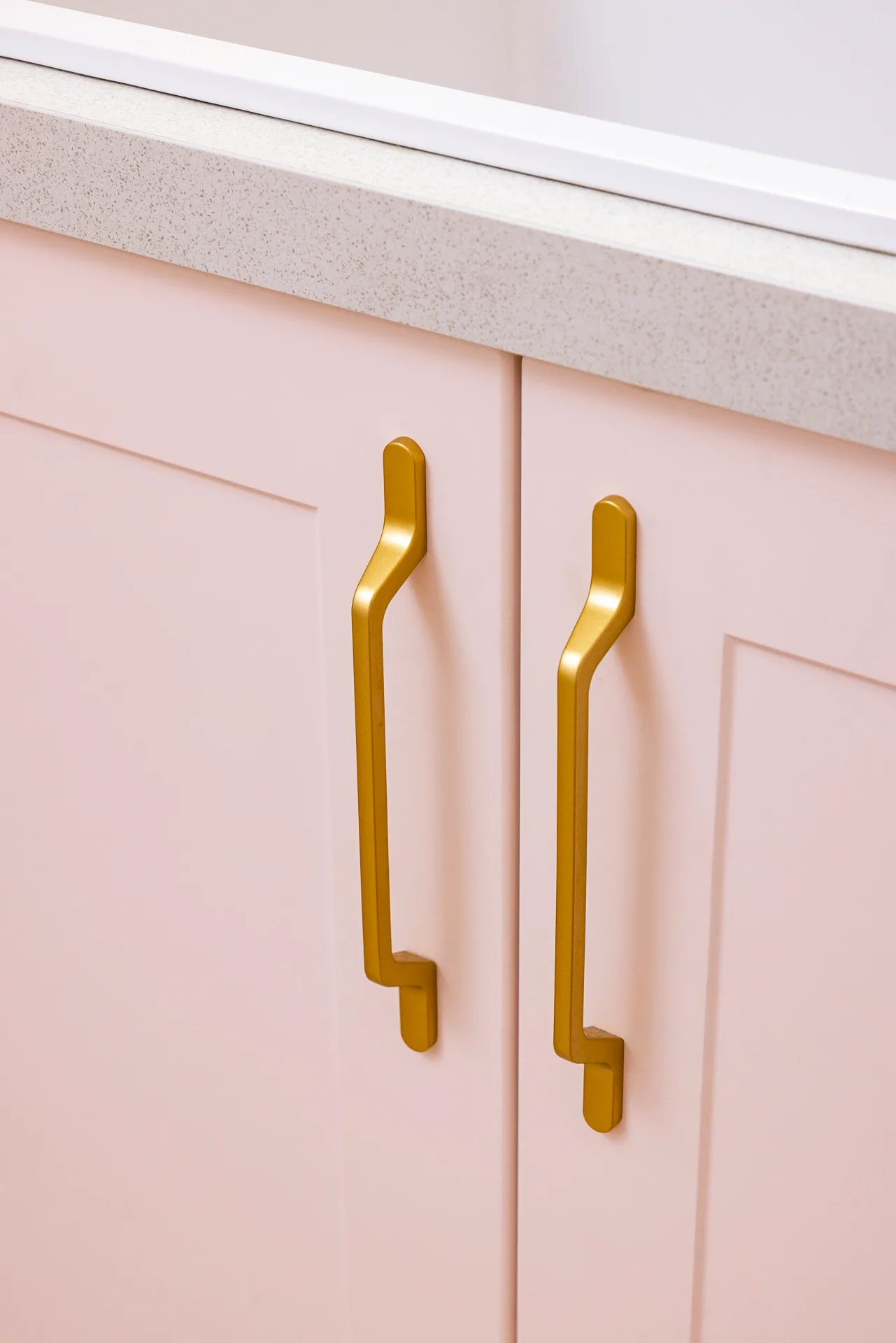Pink cabinet with gold handles