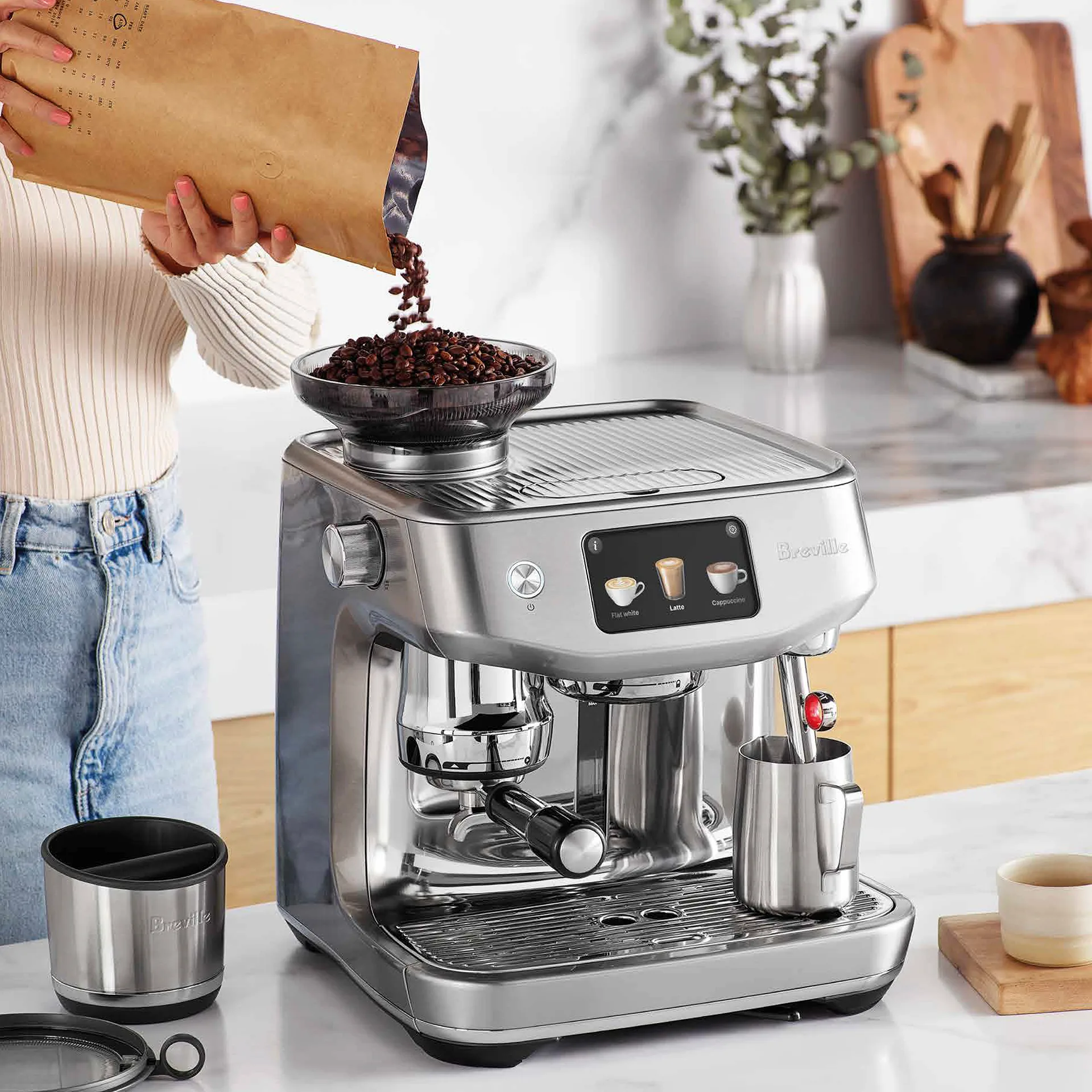 Woman filling Breville's The Oracle Jet with fresh coffee beans