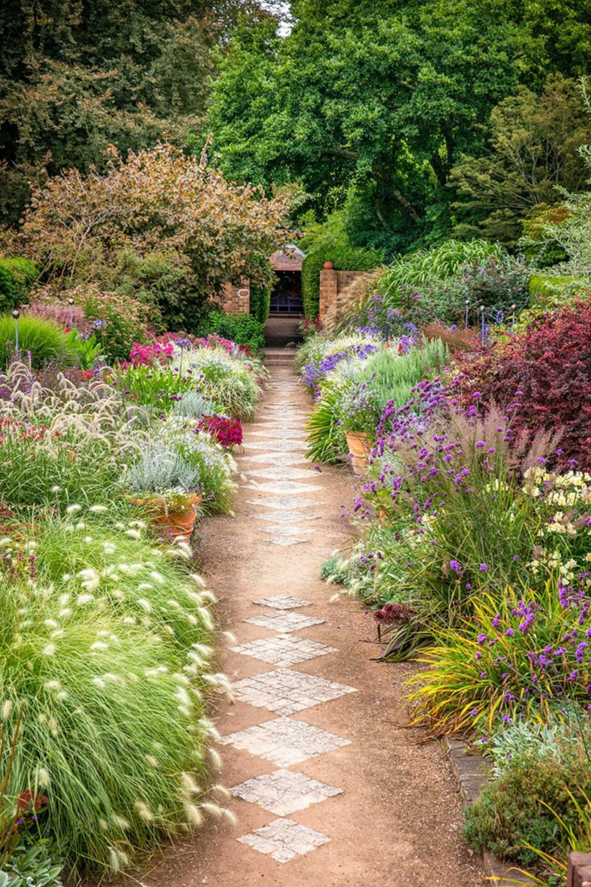 cloudehill march garden pathway with flowers lining brick stepping stones
