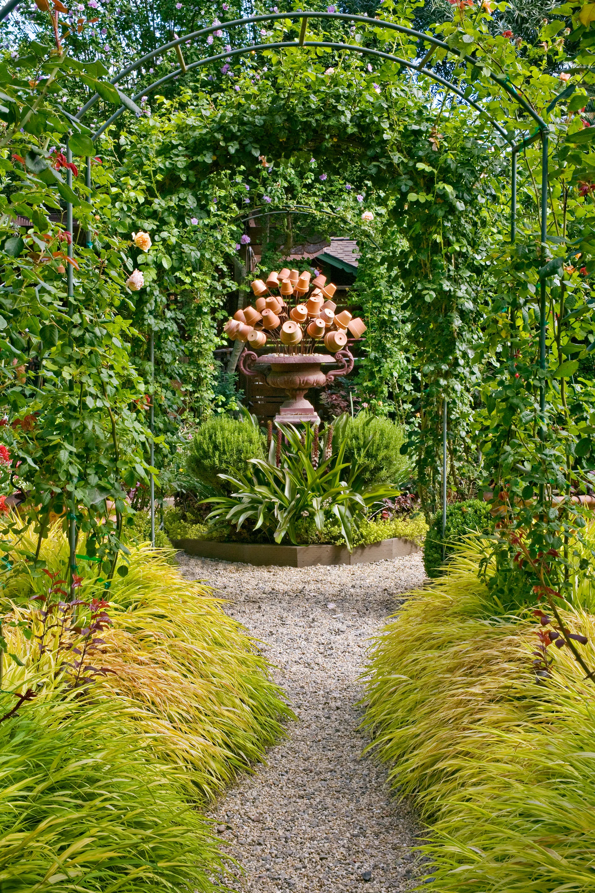 sculpture in the centre of a garden made of small clay pots