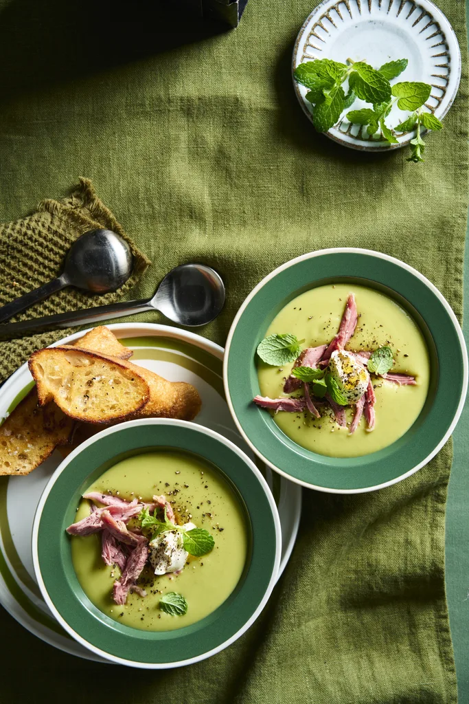 pea and ham soup in green bowls