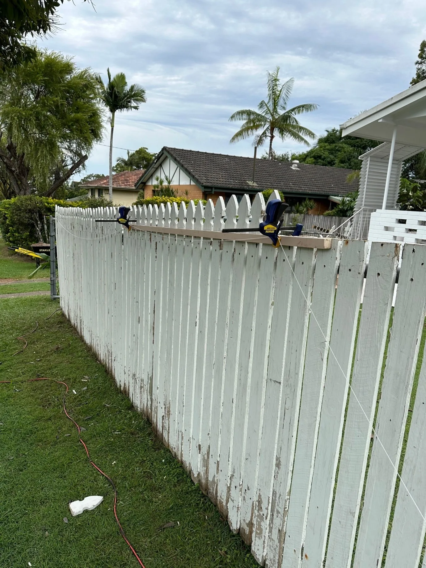 cheap fence ideas for front yard include cutting off the top 'picket' of the fence to fit the style
