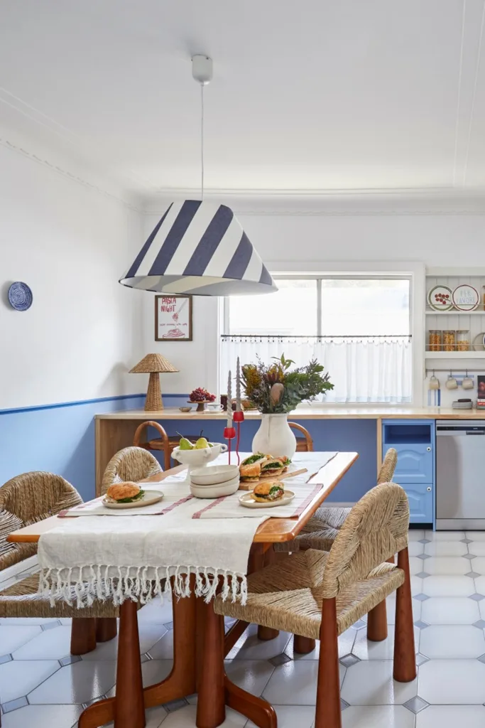 L-shaped kitchen with dining area and blue cabinetry