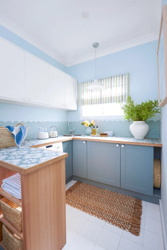 laundry makeover portrait image of new laundry blue scalloped tiles and tiled benchtop