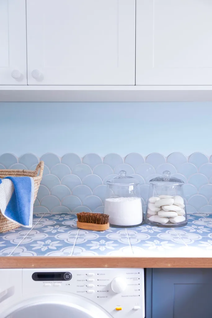 splashback closeup with cupboards and jars of detergent for removing washed tissues from clothing