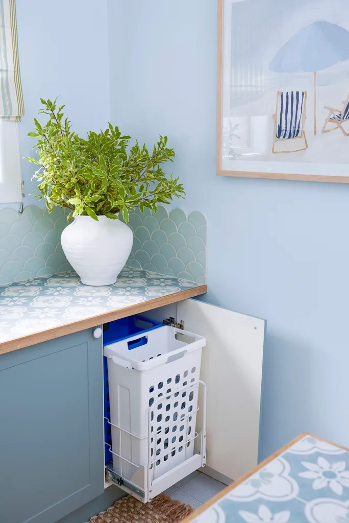 blue scalloped tiles with hidden bin and white vase