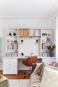 wide shot of home office desk with brown chair and hutch storage space