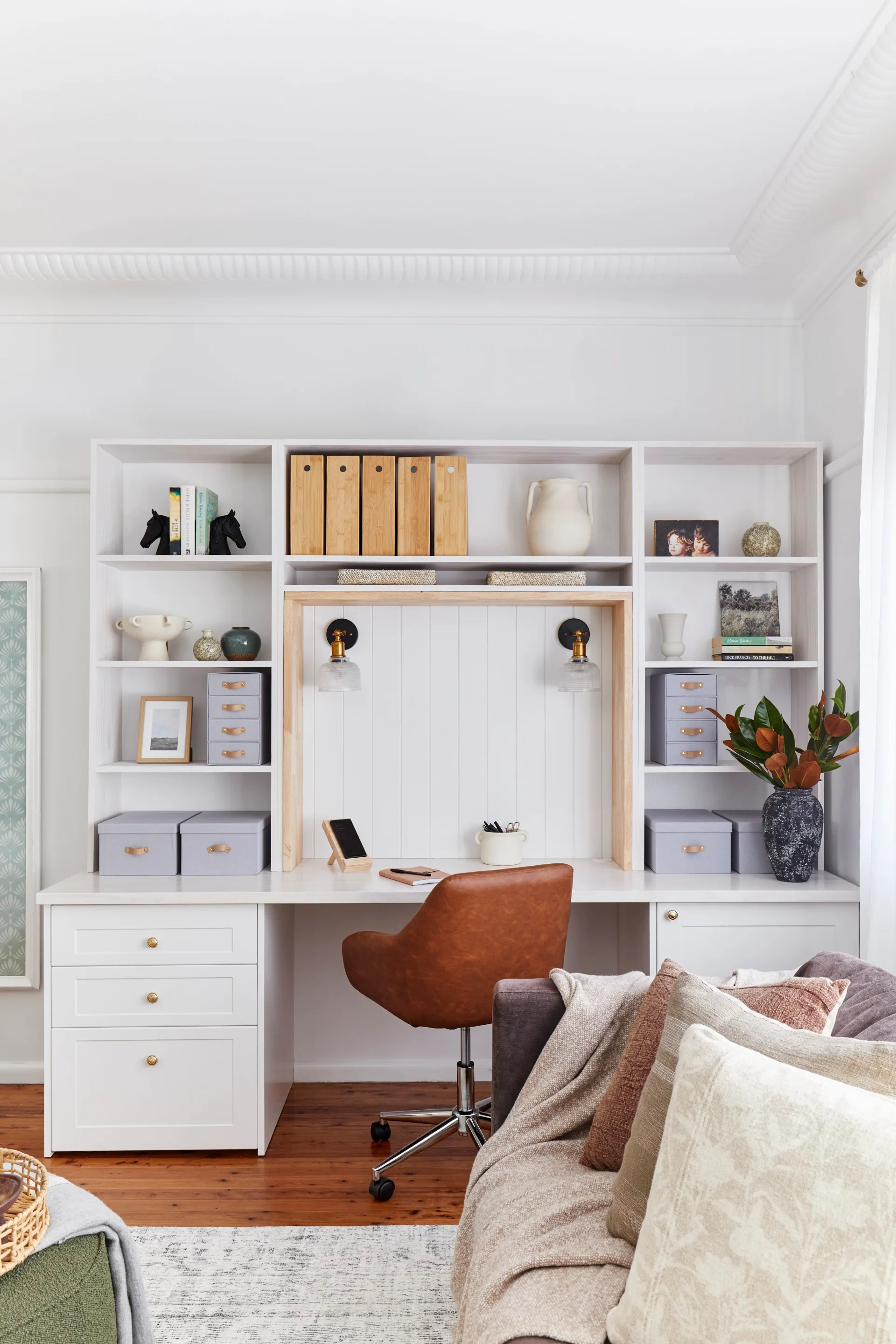 wide shot of home office desk with brown chair and hutch storage space