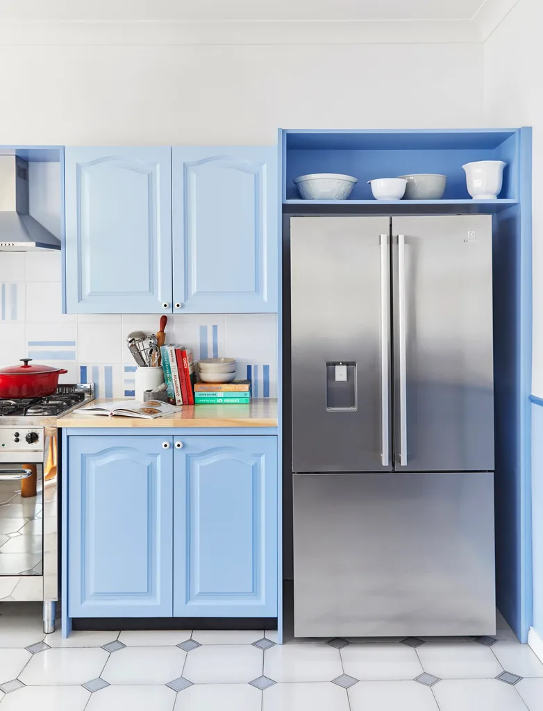 blue kitchen cabinets with fridges and painted splashback
