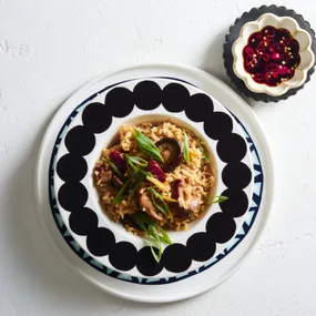 claypot chicken rice in patterned bowl with chili on the side