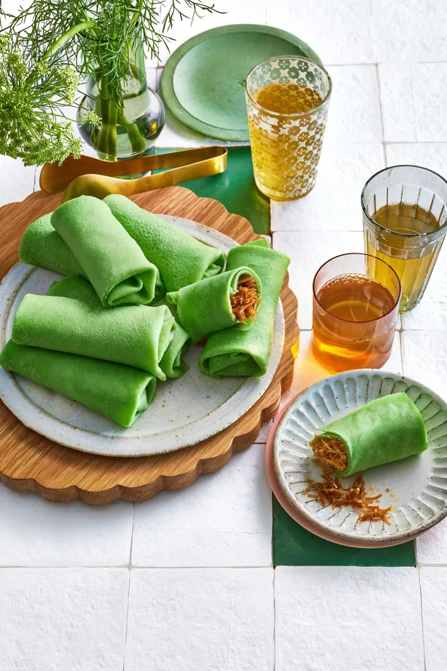 green pancake crepes rolled onto a plate