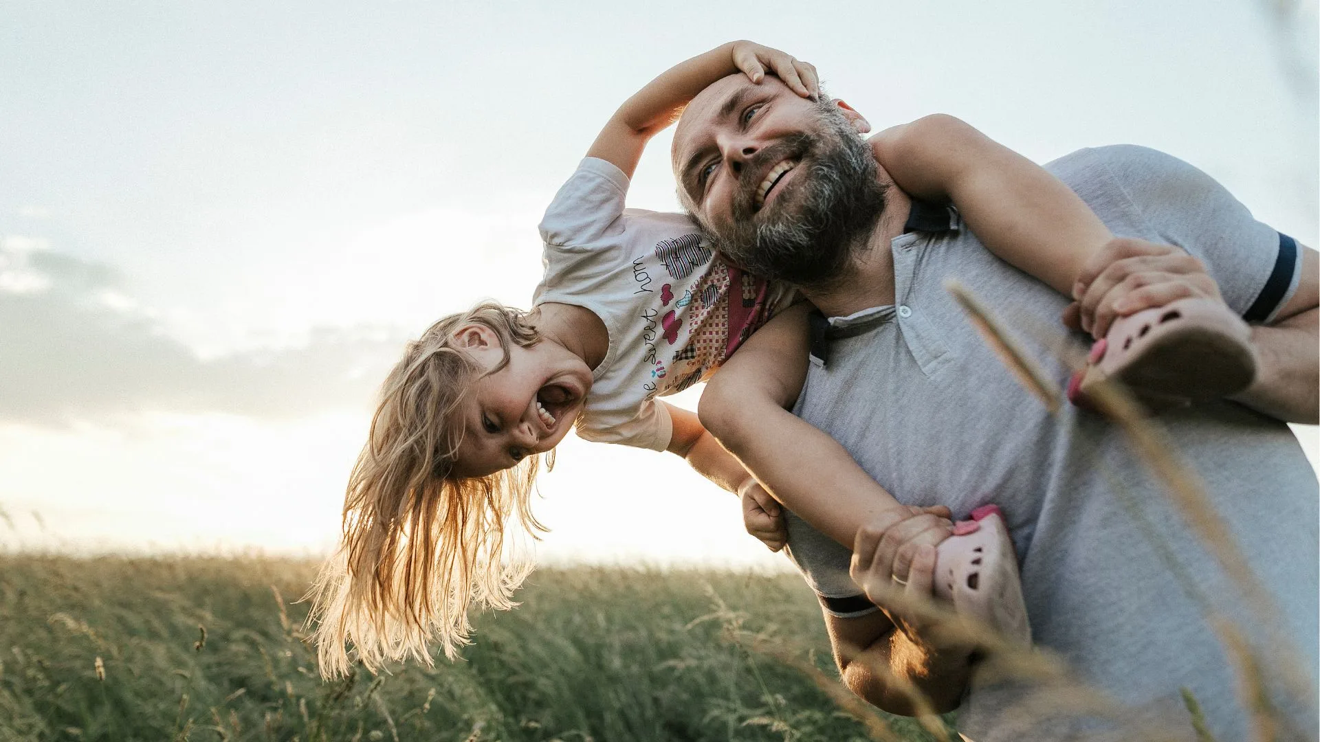 Father giving his daughter a piggy back ride