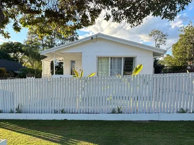 after of fence renovation white picket fence in front of white house