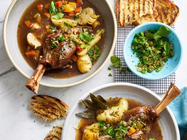 irish stew in two bowls with parsley on the side