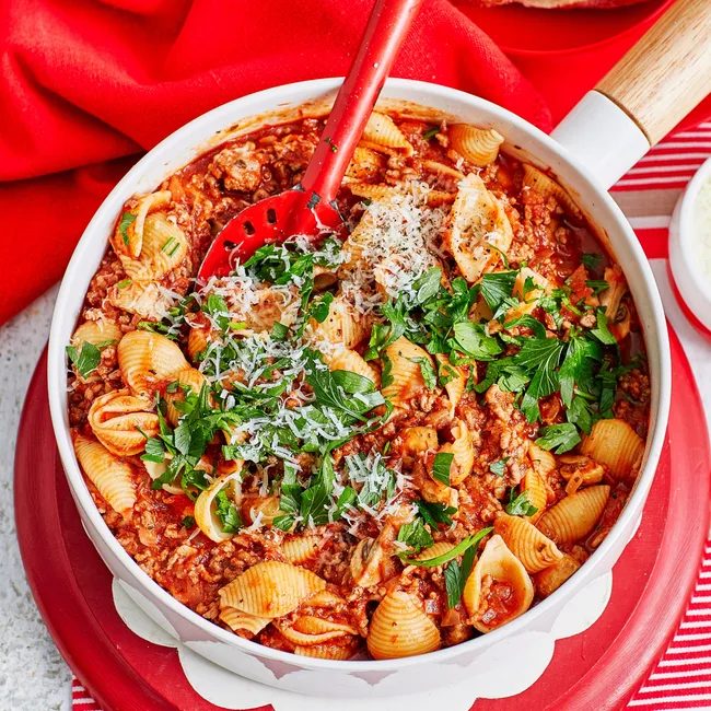 one pot bolognese in white bowl with spoon sticking out