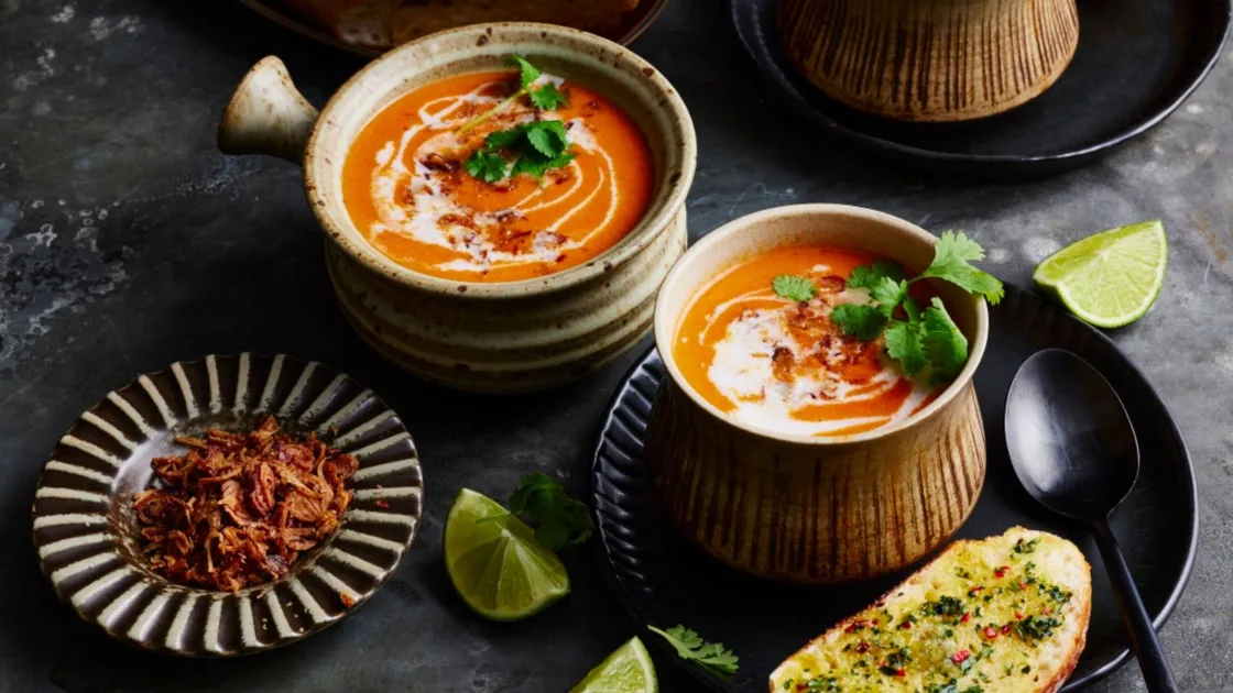 Creamy tomato tom yum soup with coriander and chilli garlic bread - Better Homes & Gardens Australia