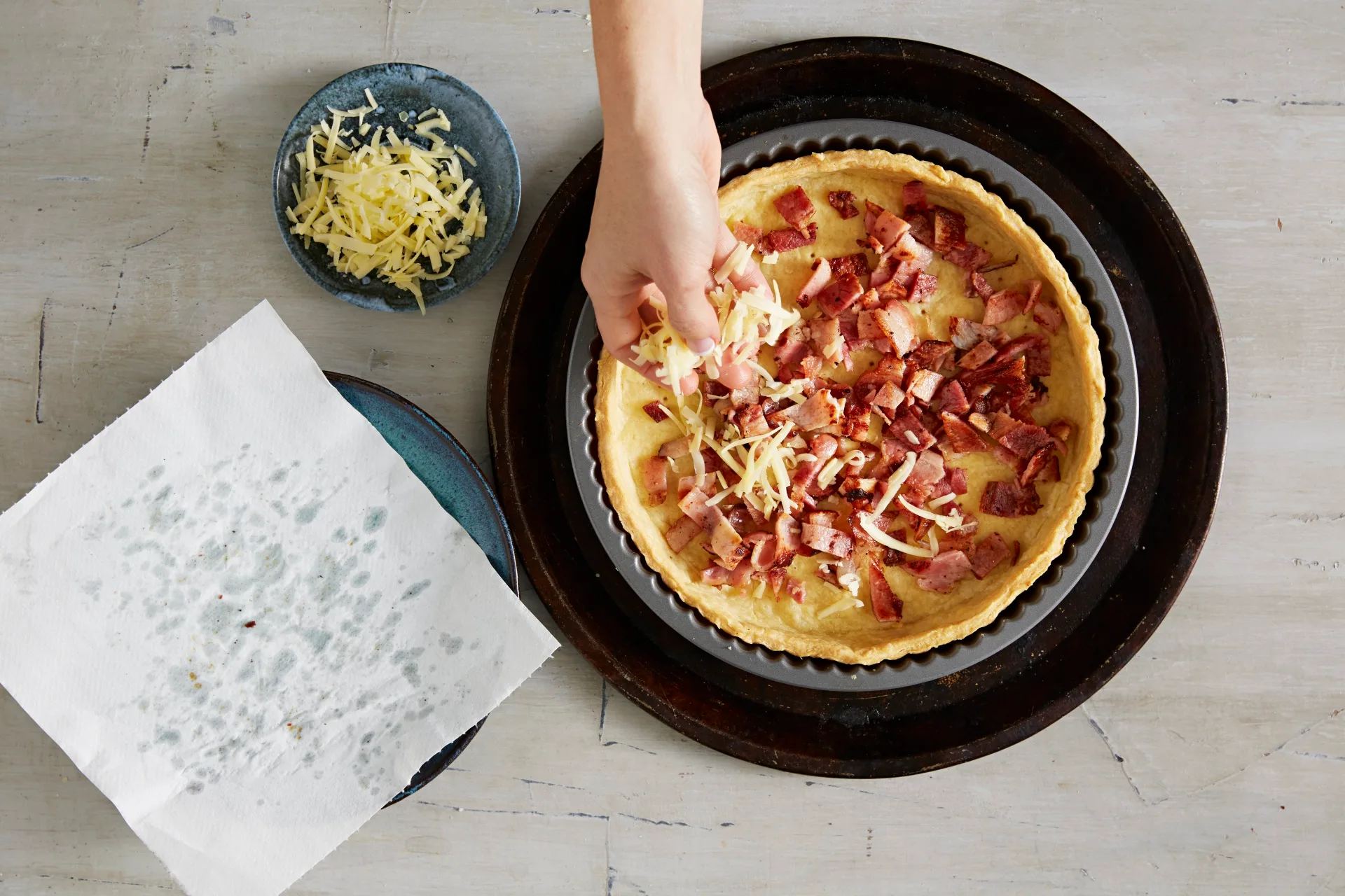 placing bacon in bottom of pie crust 