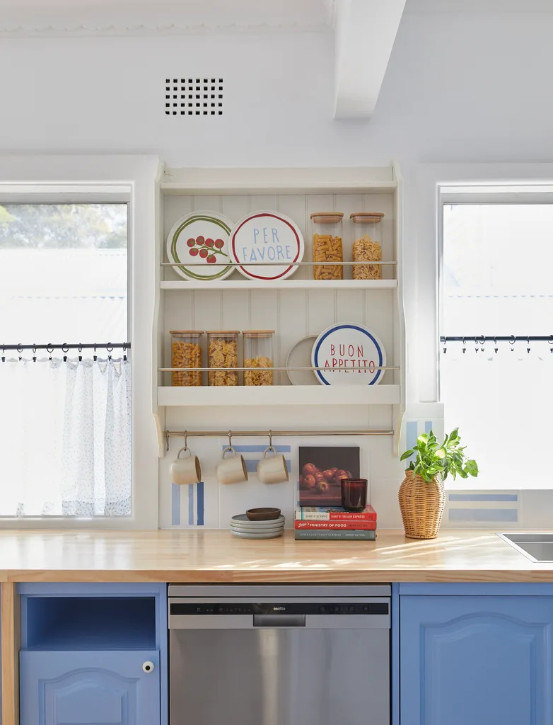Blue kitchen renovation with country style plate rack and mug rack