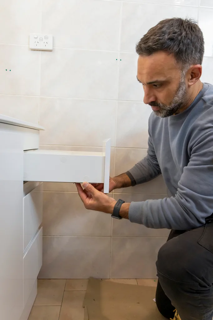 homem substituindo e instalando gavetas de bacia