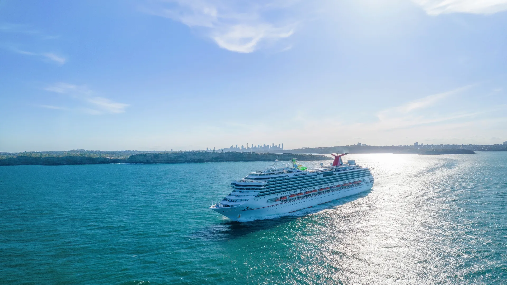 picture of cruise ship on water travelling in sunlight