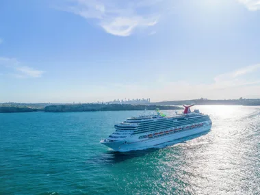 picture of cruise ship on water travelling in sunlight