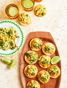 corn tostadas on a pink tray with corn salsa in bowl on the side