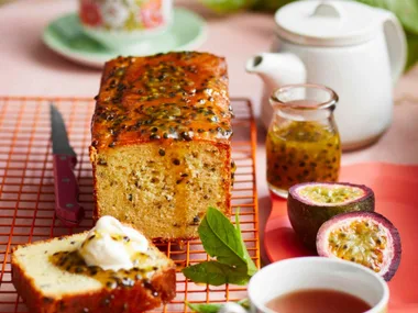 passionfruit and jasmine tea syrup cake on a table with cups of tea