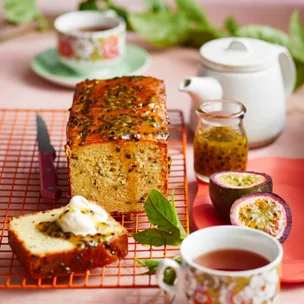 passionfruit and jasmine tea syrup cake on a table with cups of tea