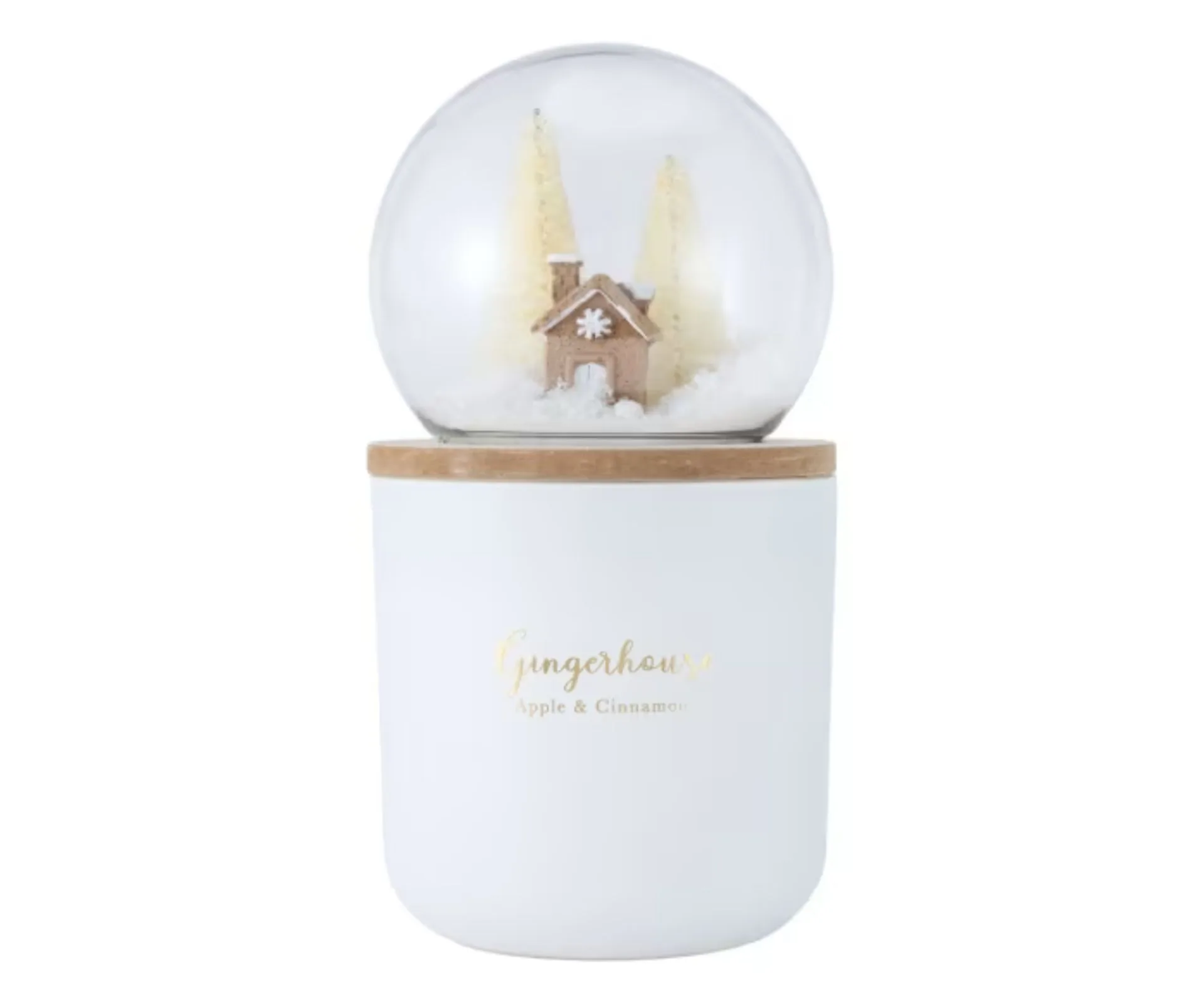 white scented candle with a snow globe attached on top