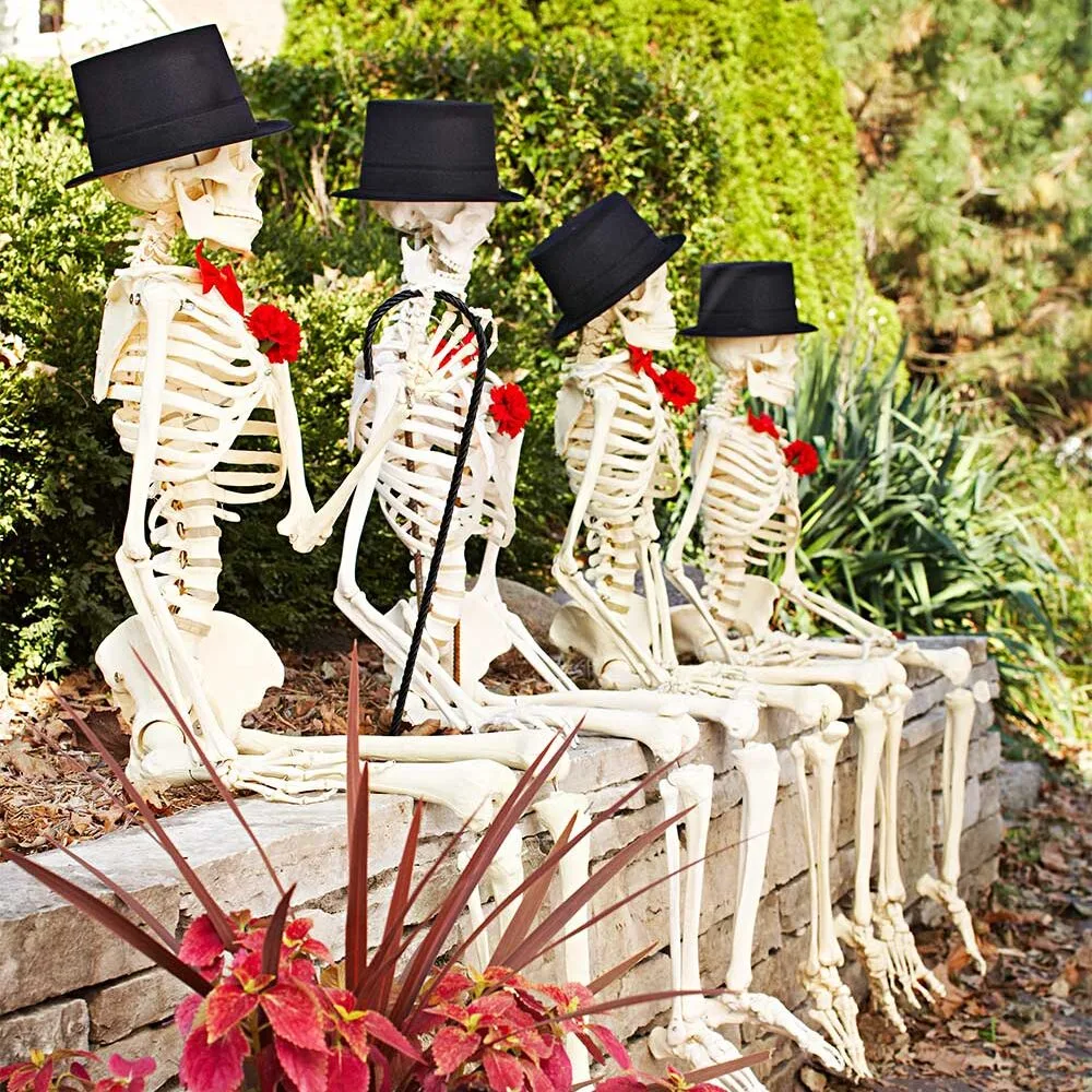 Funny Halloween skeletons posing in garden.