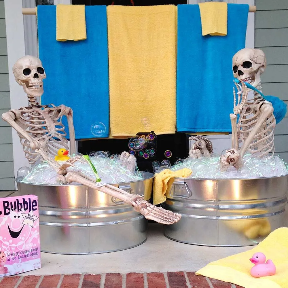 Funny Halloween skeletons posing in a bath