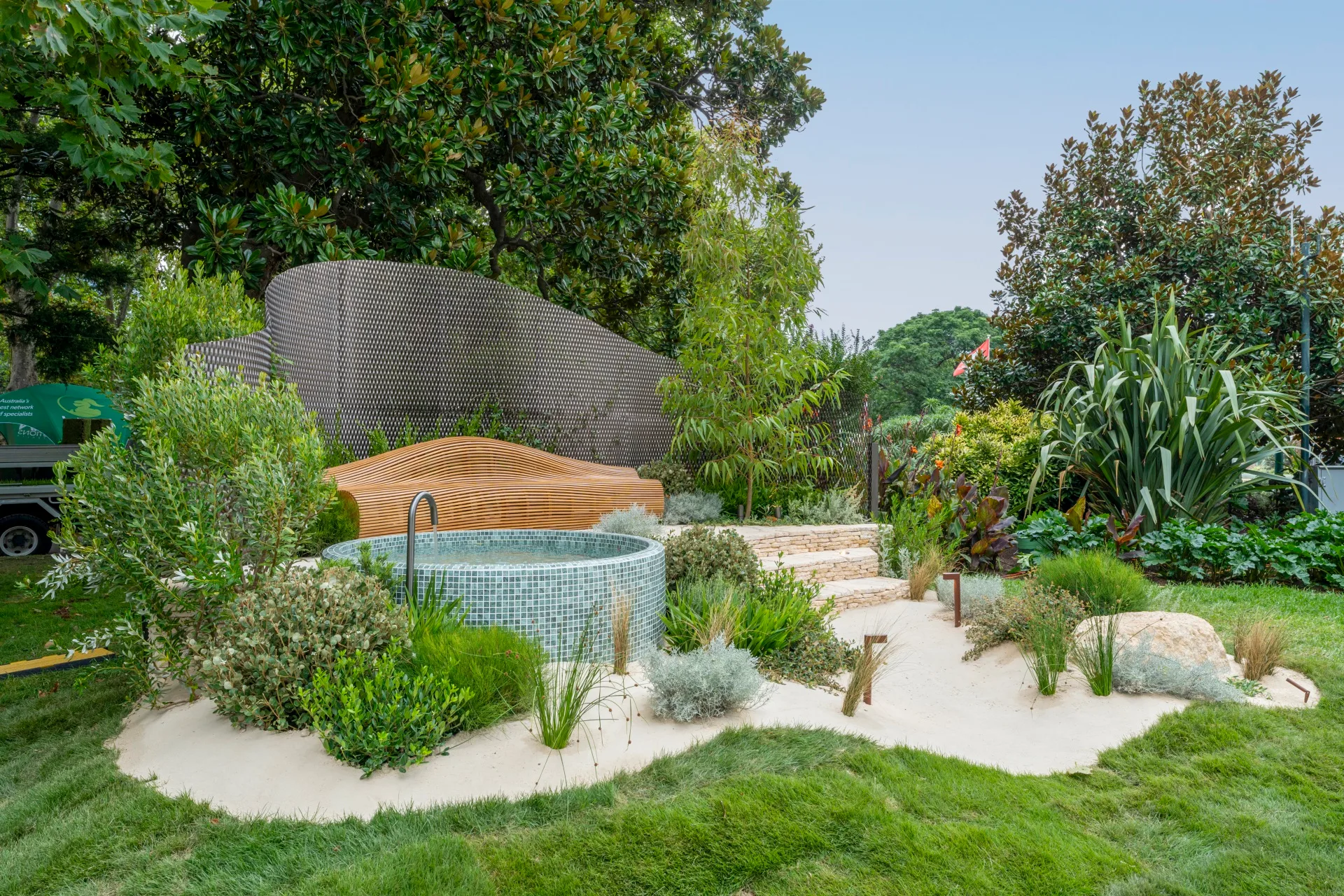 coastal design with blue tiled plunge pool, sandstone steps and curved timber features
