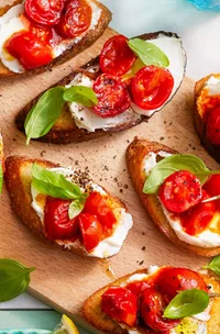 cherry tomato crostini on a board