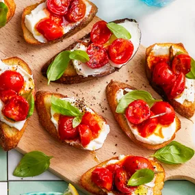 cherry tomato crostini on a board