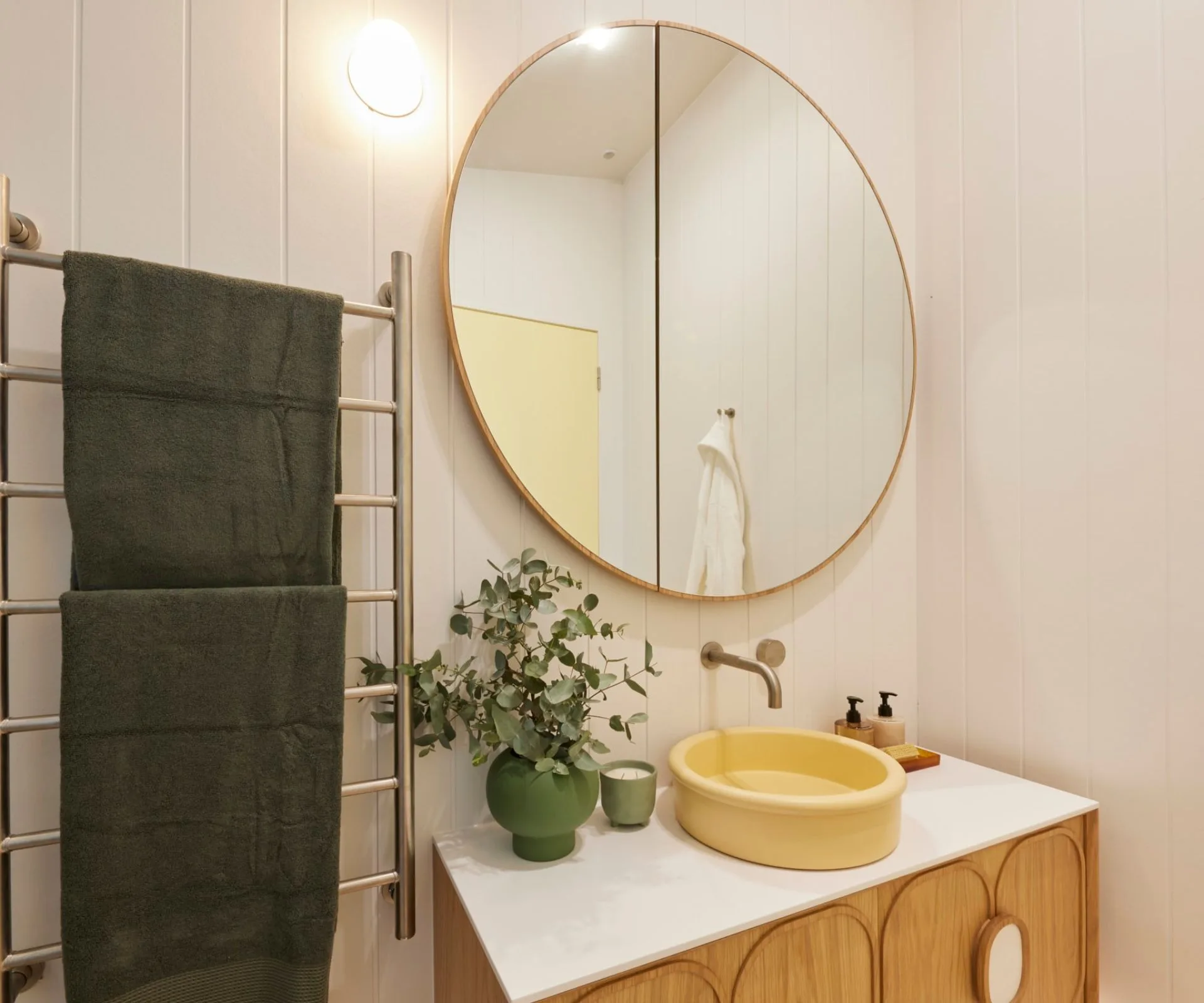 bathroom with circle mirror
