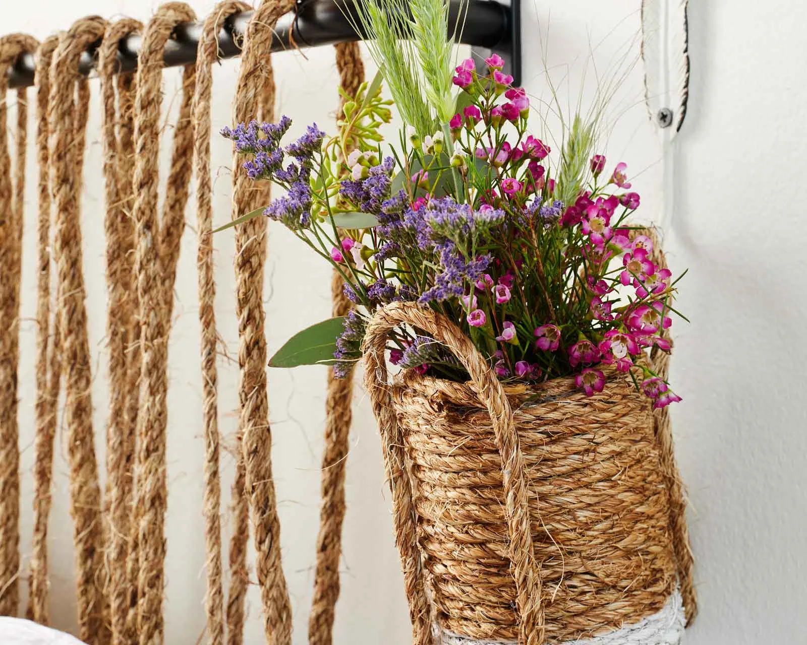 hanging vase made of rope with plants inside