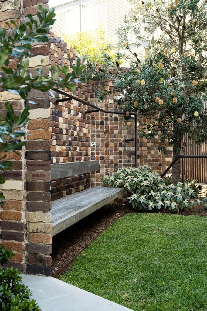 garden with a bench and large trees